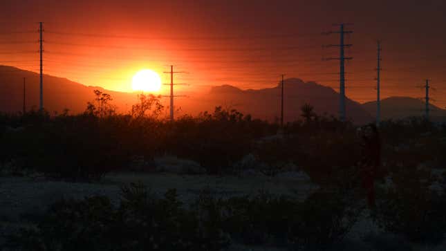 A photo of a deep red sunset over hills in America. 