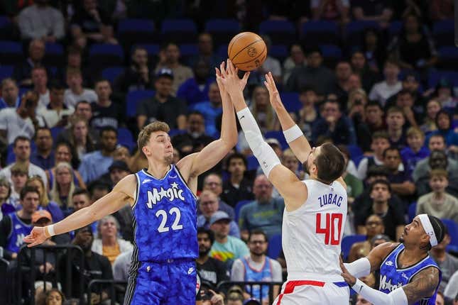 Mar 29, 2024; Orlando, Florida, USA; Orlando Magic forward Franz Wagner (22) and LA Clippers center Ivica Zubac (40) jump for the rebound during the first quarter at KIA Center.