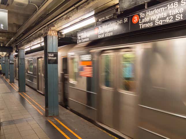 A subway train speeds out of a Wall Street station in New York City. 