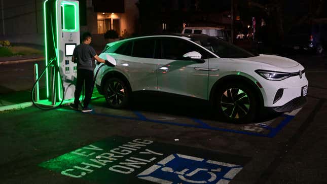 A driver charges his electric vehicle at a charging station as the California Independent System Operator announced a statewide electricity Flex Alert urging conservation to avoid blackouts in Monterey Park, California on August 31, 2022.