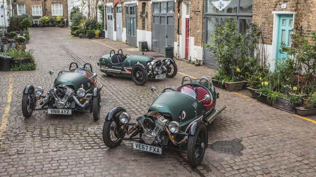 A photo of three Morgan three-wheeled sports cars. 