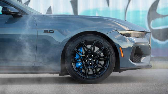 2024 Ford Mustang in blue with a blue and white graffiti in the background