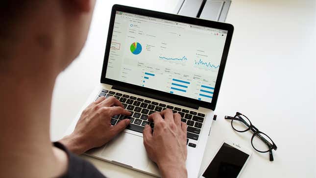 Accounting analytics are displayed on a laptop screen.