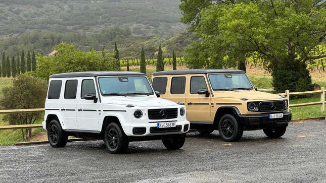 Front 3/4 view of a white Mercedes-Benz G580 EV next to a beige G580
