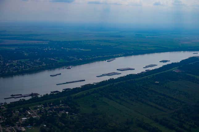 In this aerial photo, barges are seen moored during low water levels on the Mississippi River between Baton Rouge, La., and Reserve, La. in Livingston Parish, La., Thursday, Sept. 14, 2023. (AP Photo/Gerald Herbert)