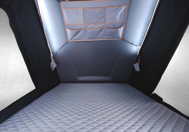 A photo of the inside of the tent showing the quilted mattress and the LED light strips