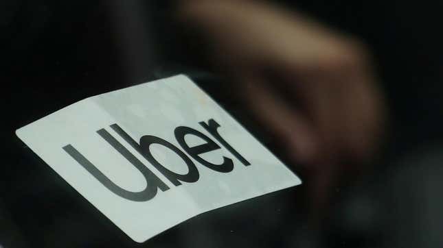 Uber logo on window of car.