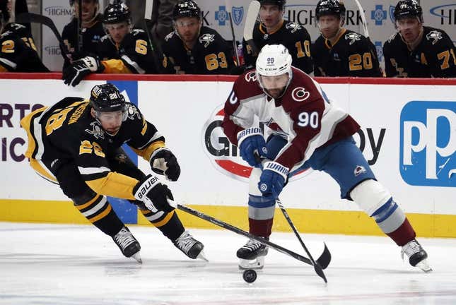 Oct 26, 2023; Pittsburgh, Pennsylvania, USA; Pittsburgh Penguins defenseman Marcus Pettersson (28) defends Colorado Avalanche left wing Tomas Tatar (90) during the first period at PPG Paints Arena.