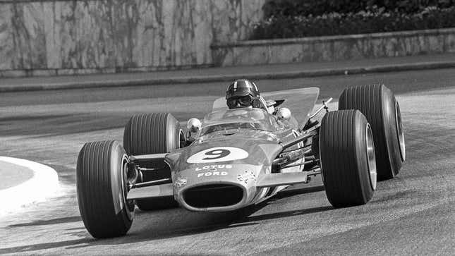 A black and white photo of a Lotus Ford Formula 1 car. 