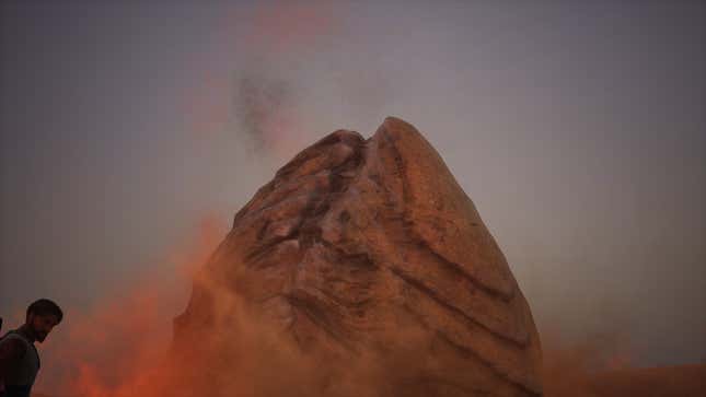 A player satanding in front of a sandworm.
