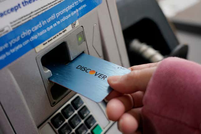 File - A Discover card is used to pay for gasoline at a Sam&#39;s Club in Madison, Miss., July 1, 2021. Capital One Financial is buying Discover Financial Services for $35 billion, in a deal that would bring together two of the nation&#39;s biggest lenders and credit card issuers. (AP Photo/Rogelio V. Solis, File)