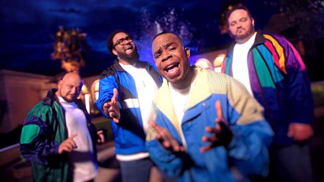 Image of R&B group All-4-One in colorful tracksuits singing "It's All There" in front of a fountain.