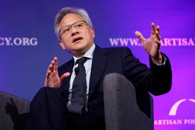 Jensen Huang sitting in a chair, speaking, with both of us hands up, in front of a purple backdrop