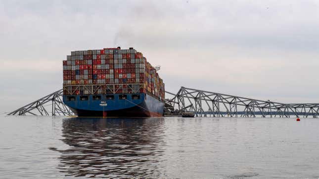 Workers start to clear the channel of the twisted metal and concrete of the Francis Scott Key Bridge, as authorities turn their focus to "salvage" operations with heavy duty cranes to remove wreckage from the Patapsco River after the massive container ship, Dali, caused the bridge to collapse on March 31, 2024.