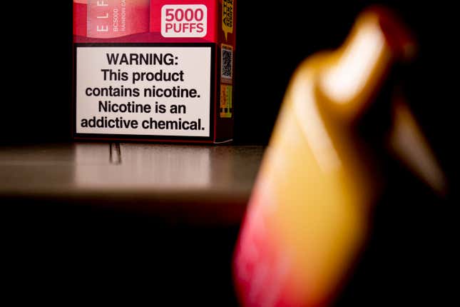 FILE - An Elf Bar disposable vaping pod device and a health warning on its packaging is displayed, Monday, June 26, 2023, in Washington. U.S. lawmakers are demanding information on federal efforts to stop the recent influx of kid-appealing electronic cigarettes from China. A letter sent Thursday, Dec. 7, 2023, by a congressional committee investigating Chinese policies called attention to “the extreme proliferation of illicit vaping products.” (AP Photo/Andrew Harnik, File)