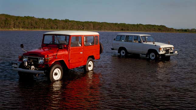 Two vintage Toyota Land Cruisers parked in a lake. 