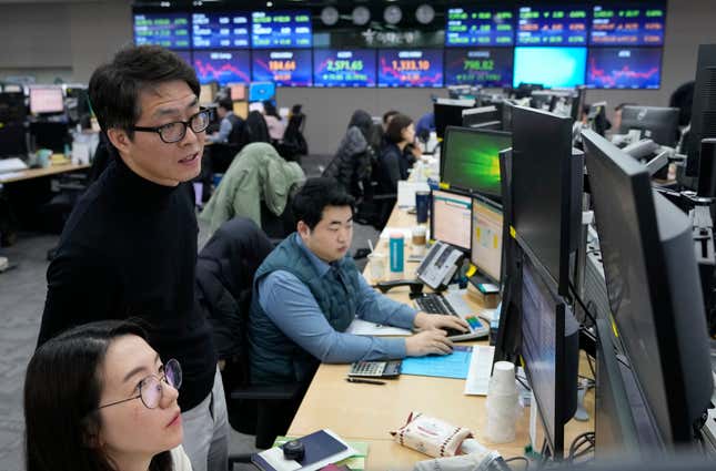 Currency traders watch monitors at the foreign exchange dealing room of the KEB Hana Bank headquarters in Seoul, South Korea, Tuesday, Feb. 6, 2024. Shares are mixed in Asia, where Chinese markets advanced after a government investment fund said it would step up stock purchases. (AP Photo/Ahn Young-joon)