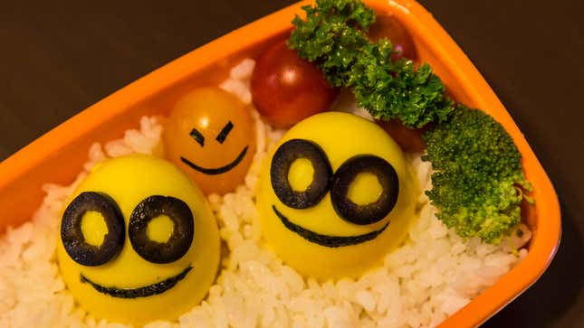 A photo of a lunch box full of food. 