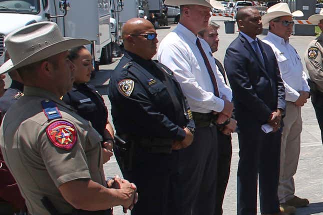 Uvalde School Police Chief Pete Arredondo, third from left, stands during a news conference outside of the Robb Elementary school in Uvalde, Texas Thursday, May 26, 2022.