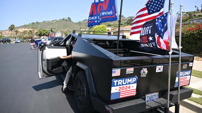 Jay Song, 54, US-Korean supporter of former US President and Republican presidential candidate Donald Trump drives his Tesla Cybertruck flying a US, South Korea and "Trump Won" flags as he tried to catch a glimpse of Trump giving a press conference outside Trump National Golf Club Los Angeles in Rancho Palos Verdes, California, on September 13, 2024. 