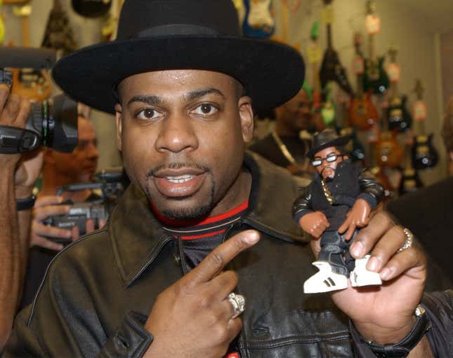 Musical artist Jason “Jam Master Jay” Mizell holds a toy figure of himself at a ceremony honoring his hip-hop group RUN-DMC’s induction into the Hollywood RockWalk February 25, 2002 at the Guitar Center in Hollywood, California. (Photo by Vince Bucci/Getty Images)