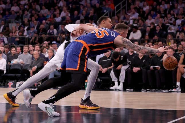 Nov 8, 2023; New York, New York, USA; San Antonio Spurs center Victor Wembanyama (1) and New York Knicks center Isaiah Hartenstein (55) fight for a loose ball during the second quarter at Madison Square Garden.