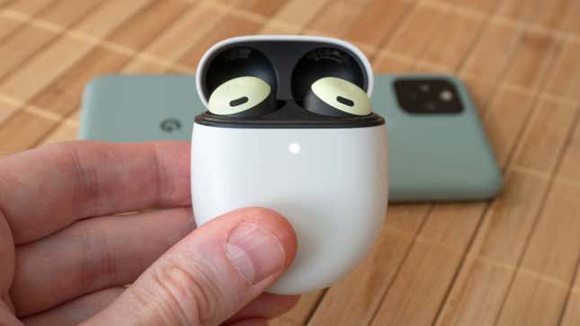 A photo of a person holding the Pixel Buds Pro charging case with the buds inside.