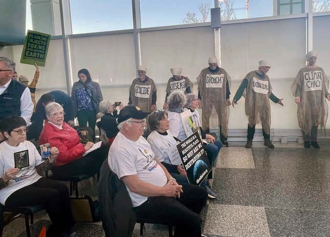 Protesters pack a meeting of the Ohio Oil and Gas Land Management Commission in Columbus, Ohio on Monday, Feb. 26, 2024. The commission awarded bids to frack for oil and under public land Monday, including state parks and designated wildlife areas, to several oil and gas companies. (AP Photo/Samantha Hendrickson)