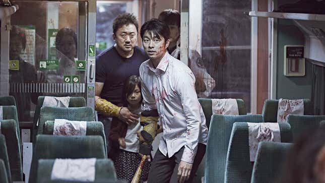 The main characters of Train to Busan, apprehensively walking down a train car. 