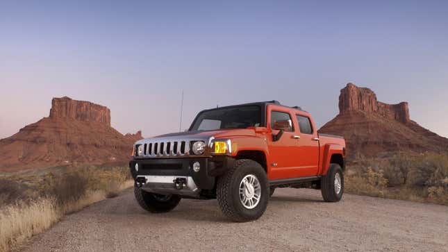 A photo of an orange Hummer H3 pickup truck. 