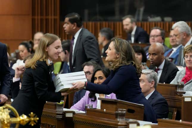 Canada&#39;s Deputy Prime Minister and Minister of Finance Chrystia Freeland, center, tables the federal budget in the House of Commons in Ottawa, Ontario, on Tuesday, April 16, 2024. The Liberal government has already unveiled significant planks of the budget, including billions of dollars to build more homes, expand child care and beef up the military. (Adrian Wyld/The Canadian Press via AP)