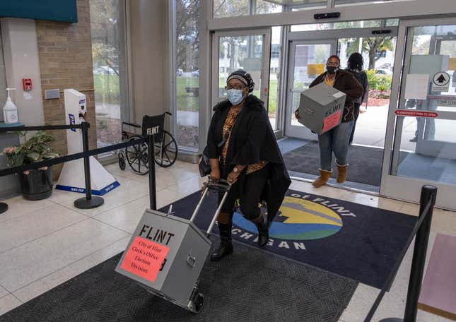 Voting boxes are brought into City Hall in Flint, Michigan October 20, 2020. 