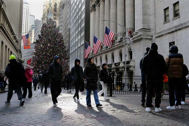 Pedestrians pass the New York Stock Exchange on Tuesday, Jan. 2, 2024 in New York. The S&amp;P 500 was lower in midday trading after pulling to the brink of its all-time high set roughly two years ago. (AP Photo/Peter Morgan)