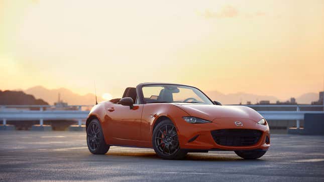 A photo of an orange Mazda Miata sports car. 