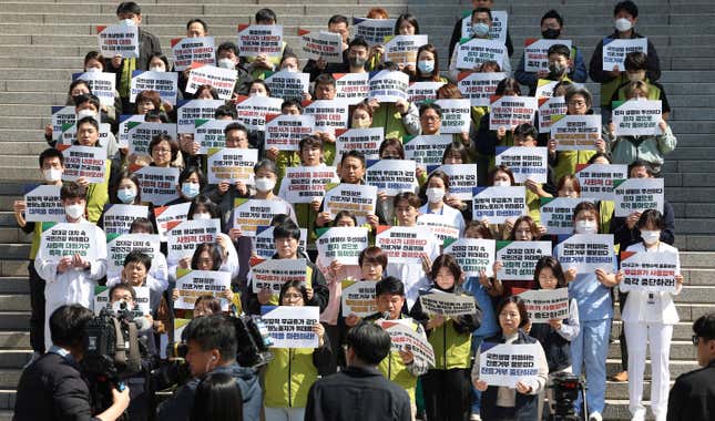 Unionized medical workers stage a rally demanding trainee doctors to return to work in front of Severance Hospital in Seoul, South Korea, Monday, April 1 2024, The signs read, &quot;To promote social dialogue to normalize medical treatment and stop refusing treatment.&quot; South Korea&#39;s President Yoon Suk Yeol vowed Monday not to back down in the face of vehement protests by doctors seeking to derail his plan to drastically increase medical school admissions, as he called their walkouts &quot;an illegal collective action&quot; that poses &quot;a grave threat to our society.&quot;(Kim Sung-min/Yonhap via AP)