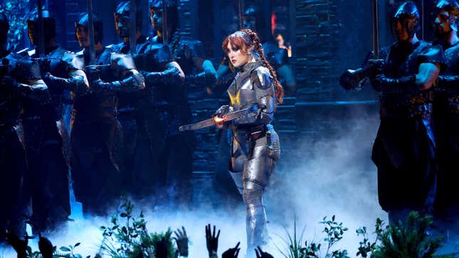 Chappell Roan holds a crossbow on the VMA stage.