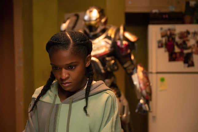 Riri Williams staring with the suit behind her