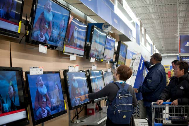 Shoppers look at televisions at Walmart in Quincy, Massachusetts.
