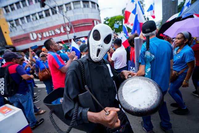 A striking teacher wearing a Halloween costume protests against a recently approved mining contract between the government and Canadian mining company First Quantum outside the National Assembly, in Panama City, Monday, Oct. 30, 2023. Panamanian President Laurentino Cortizo announced a referendum on Dec. 17, to define the future of the contract. (AP Photo/Arnulfo Franco)