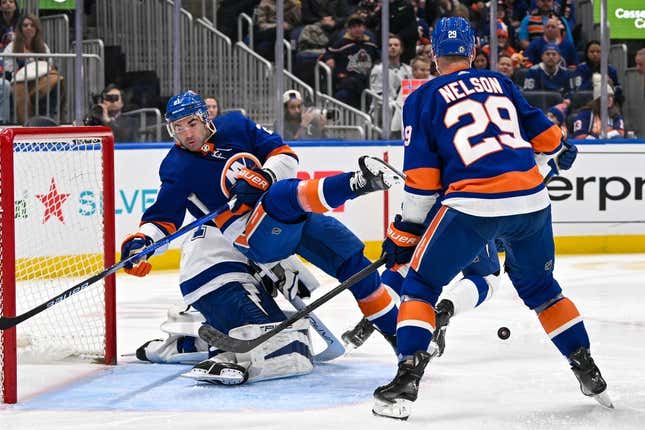 Feb 8, 2024; Elmont, New York, USA; New York Islanders center Kyle Palmieri (21) falls over Tampa Bay Lightning goaltender Jonas Johansson (31) during the second period at UBS Arena.