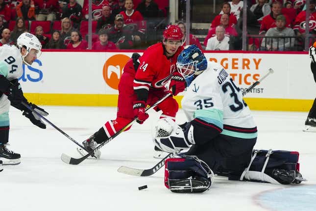 Oct 26, 2023; Raleigh, North Carolina, USA; Carolina Hurricanes center Seth Jarvis (24) scoring attempt is stopped by Seattle Kraken goaltender Joey Daccord (35) during the first period at PNC Arena.