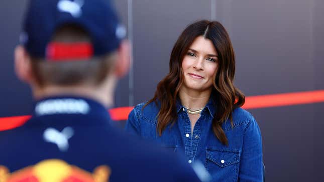 Danica Patrick talks with Max Verstappen of the Netherlands and Oracle Red Bull Racing in the Paddock during practice ahead of the 2022 United States Grand Prix