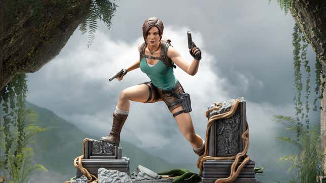 The Lara Croft statue shows her holding two pistols and scaling a broken ruin.