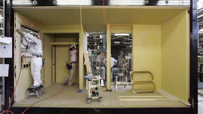 A photo of workers assembling a Toyota Home in Japan. 