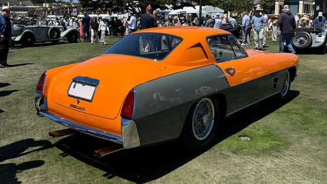 Rear 3/4 view of an orange and grey 1954 Ferrari 375 MM Ghia Coupe