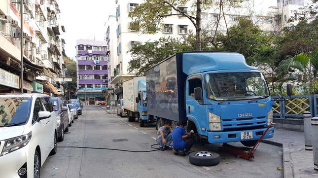 Image for article titled The Most Dedicated Mechanics In The World Wrench On The Streets Of Hong Kong