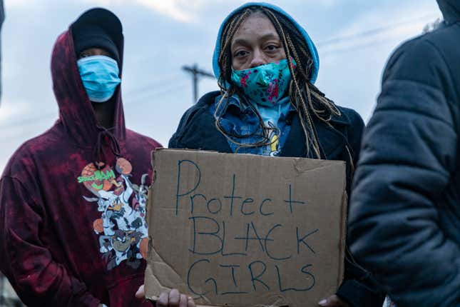 Vigil attendee holds a sign advocating to protect Black girls in Columbus, Ohio on April 21, 2021. The vigil was for Ma’Khia Bryant, 16, who was shot and killed by Columbus Police on April 20, 2021.The vigil was attended by activists and friends and family of Ma’Khia. 