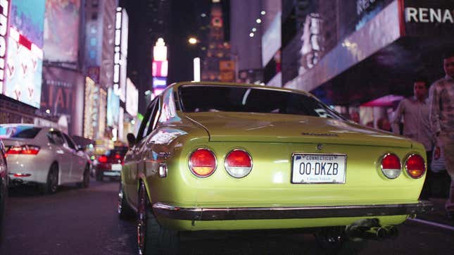 A Mazda RX-2 waits in Time Square traffic as part of the 7s Day run in 2018.