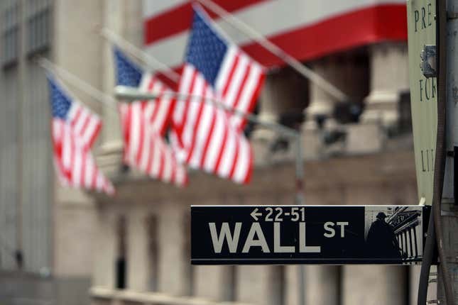 A Wall St. sign next to the New York Stock Exchange.