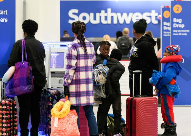 HOUSTON, TEXAS - NOVEMBER 21: Travelers check in at Southwest Airlines at George Bush Intercontinental Airport, Tuesday, Nov. 21, 2023, in Houston